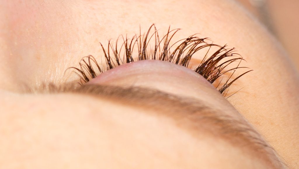 female eye with eyelashes. eyelash extension and removal concept